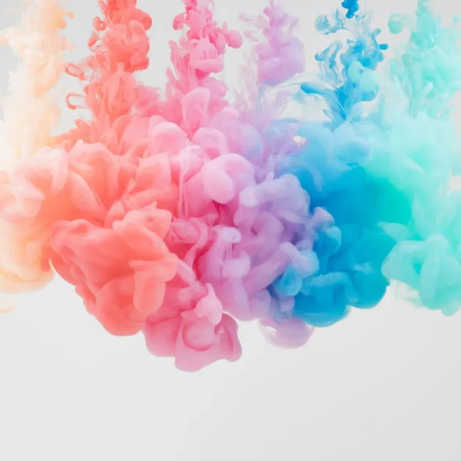 Soft clouds of pink and blue coloured smoke